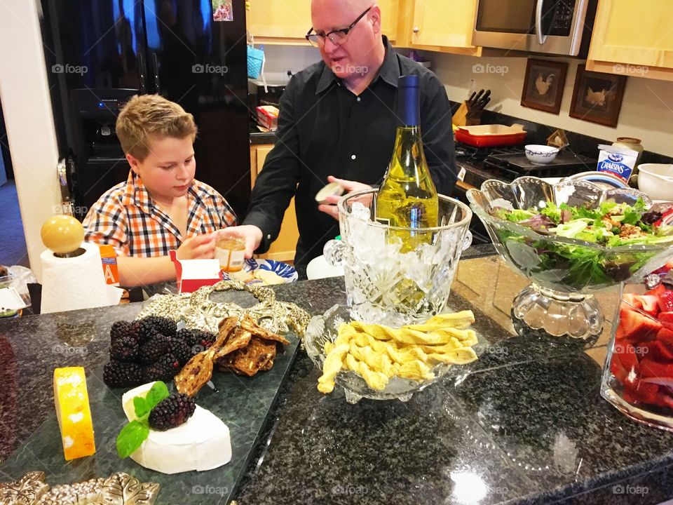 Daddy teaching his son responsibilities at home being an example