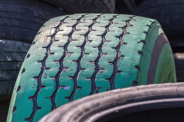 Close-up of painted green tire tracks