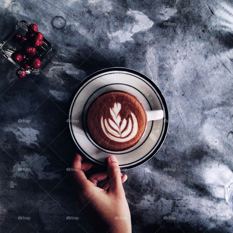 Person holding coffee cup