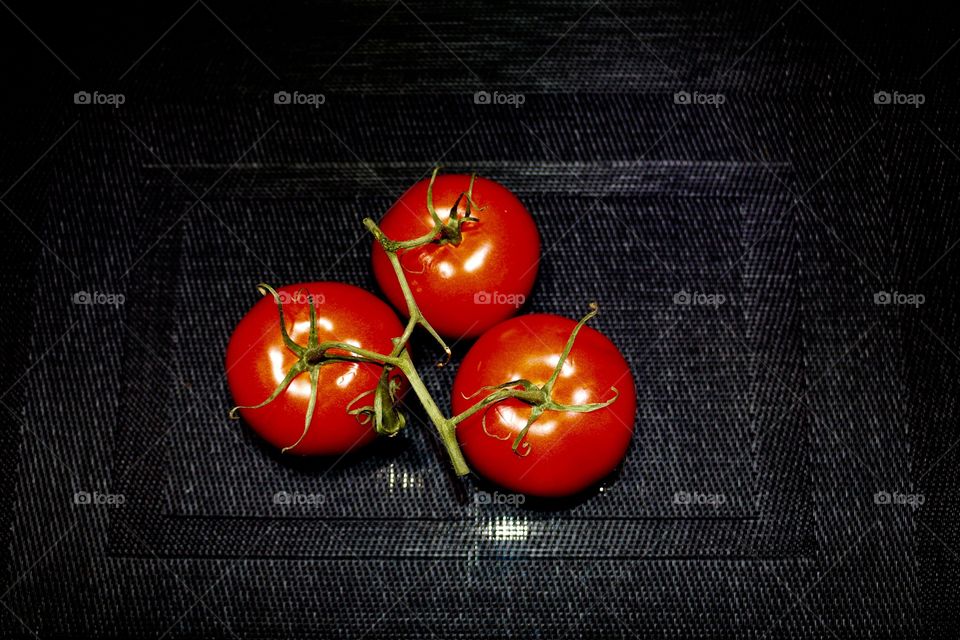 Tomatoes on a black background 