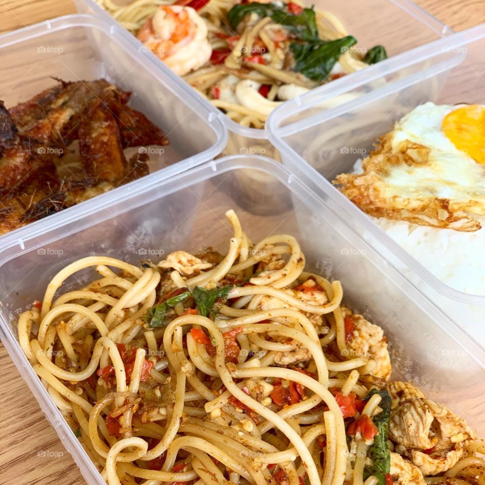 Spicy Thai western fusion meal with noodles , rice and chicken wings 