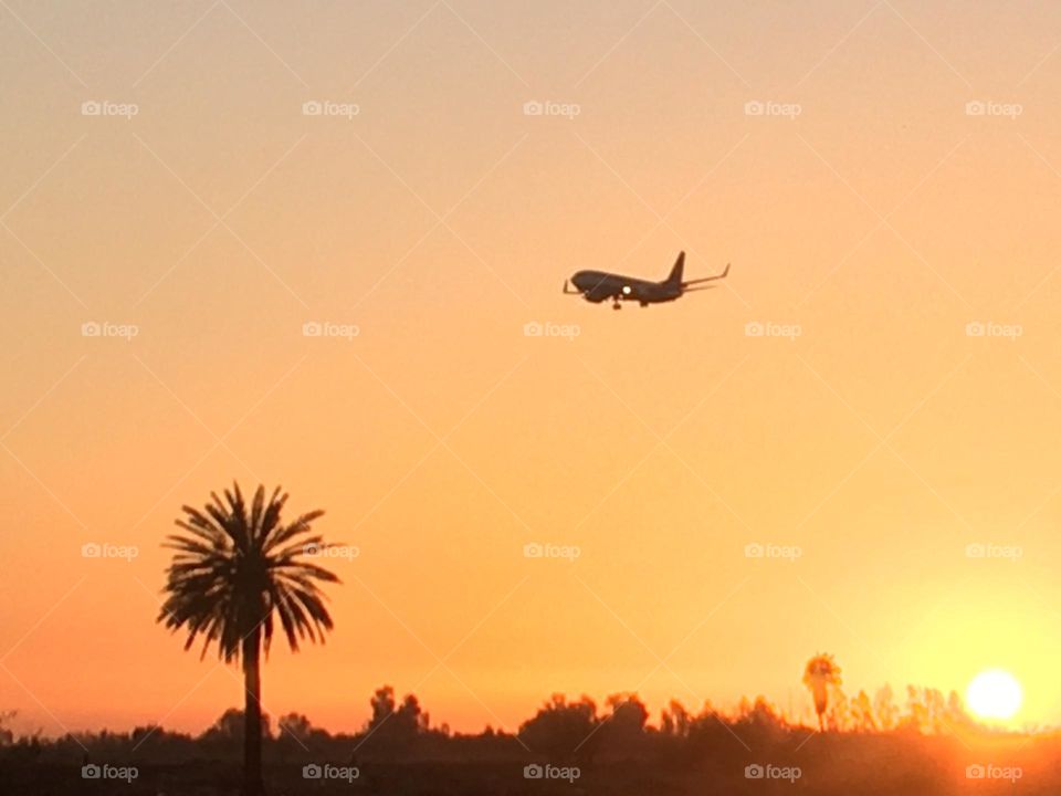 Beautiful airplane flying cross the sky and magic sunset 