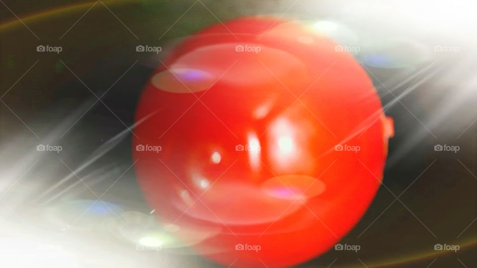 Ellipse shapes electric light focusing on a beautiful red color plastic toy ball