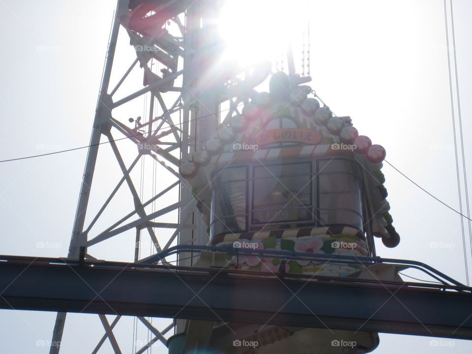 Ride at Hanayashiki Amusement Park, Asakusa, Tokyo, Japan.  Bright Sun in Sky