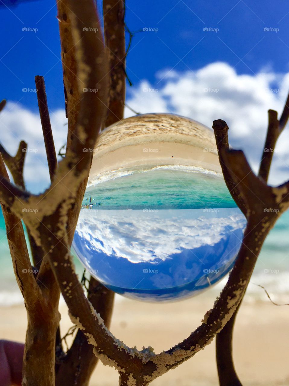 Sand, sea and sky in Freeport, Bahamas taken through a lensball creating an inverted image. 