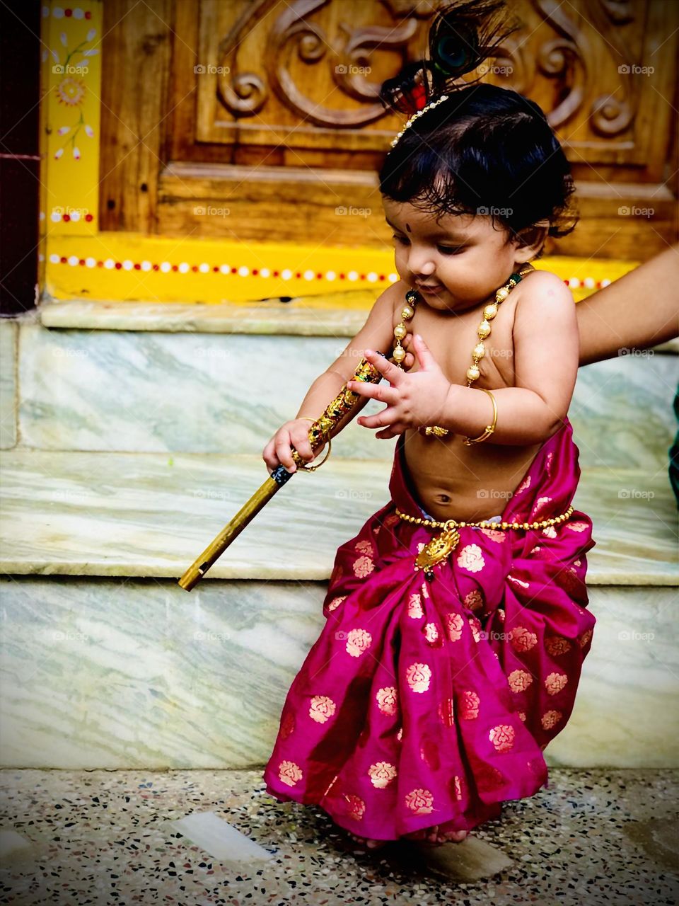 Indian Lord Little krishna in magnet colour clothes 