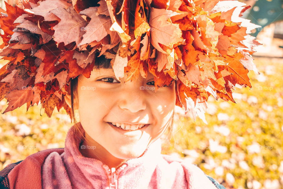 Cute girl in a leaves wreath