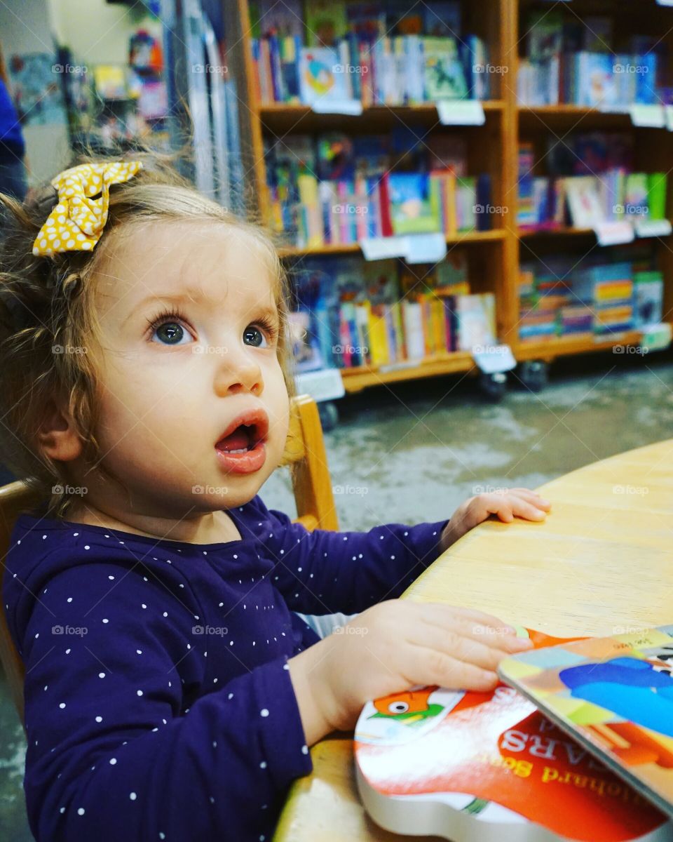 Girl sitting on chair at playgroup