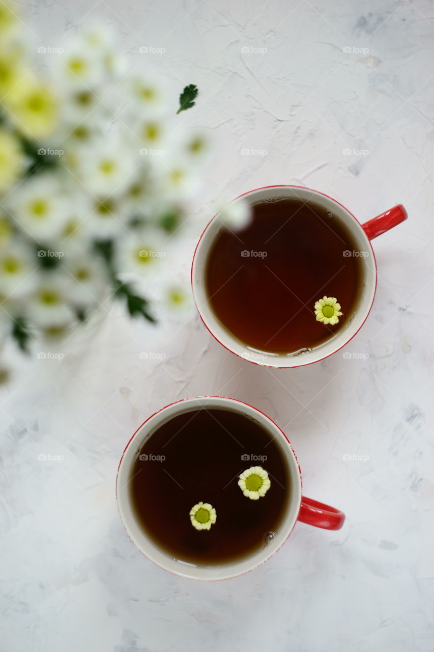 Cup of tea with white flower