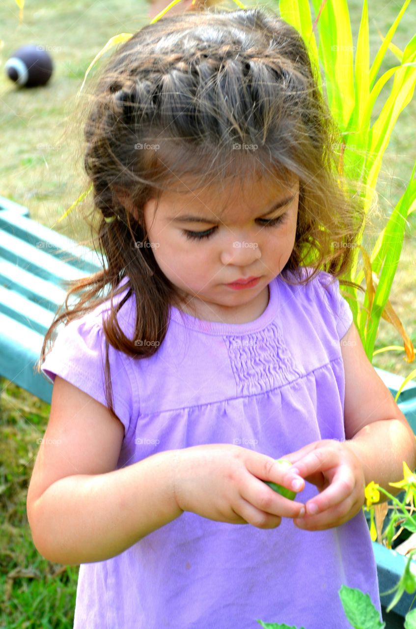 Cute girl standing near plant