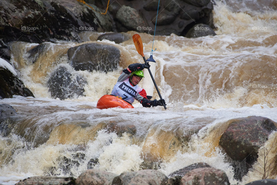 Helsinki, Finland - April 15, 2018: Unidentified racer at the annual Icebreak 2018 whitewater kayaking competition at the Vanhankaupunginkoski rapids in Helsinki, Finland.