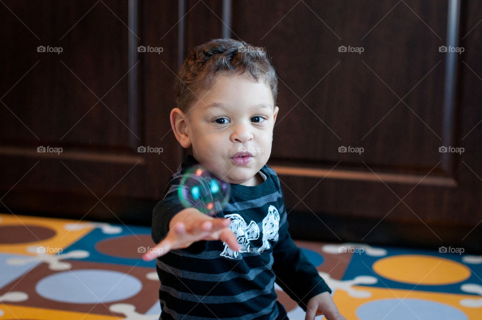 Boy catching bubbles