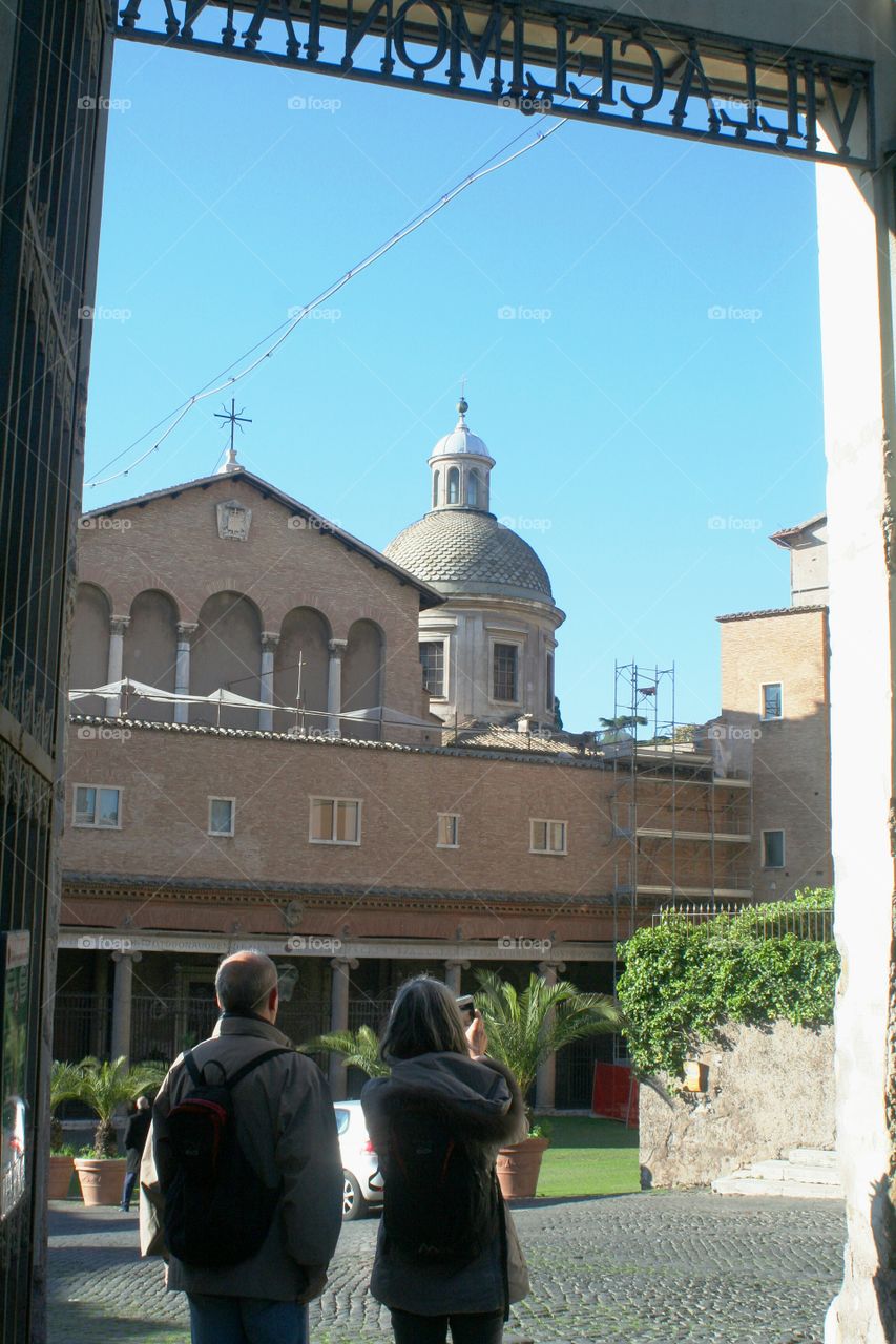 Tourists enjoy the view, walking across Rome