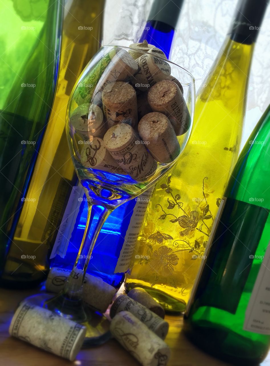 Wine bottles and corks and a glass 