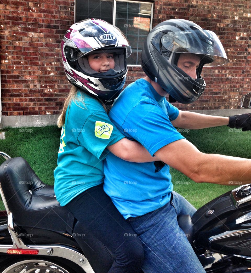 Here we go!. Dad and daughter going on a motorcycle ride 