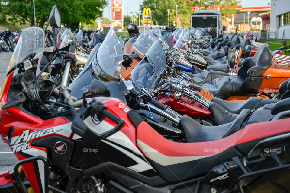 a large collection of motorcycles parked outside a hotel in Denmark.