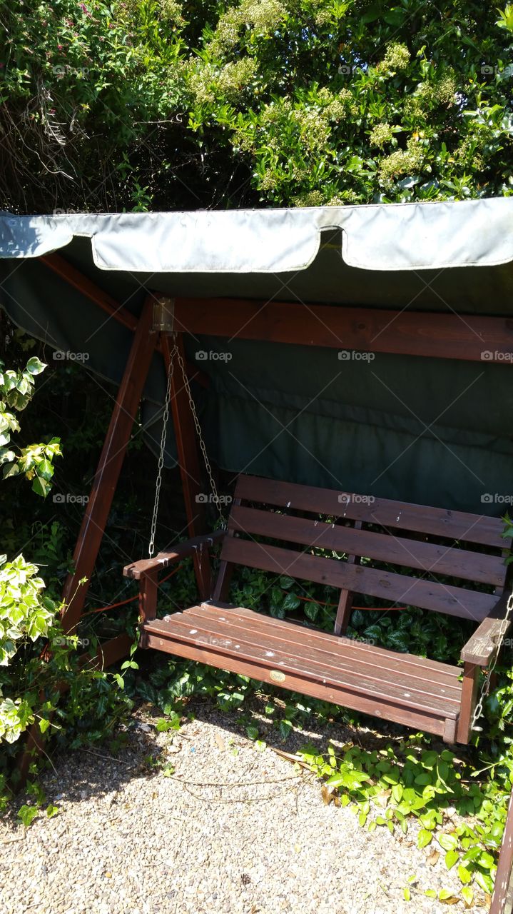 shaded open empty swing bench