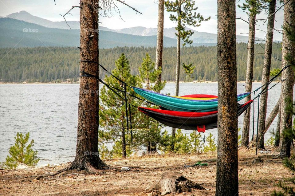 Hammocks in mountain scene. Idyllic setting just outside of Leadville Colorado. Hiking, biking, & camping in lake setting with panoramic mountain views. Peaceful setting for a vacation or day trip to the mountains
