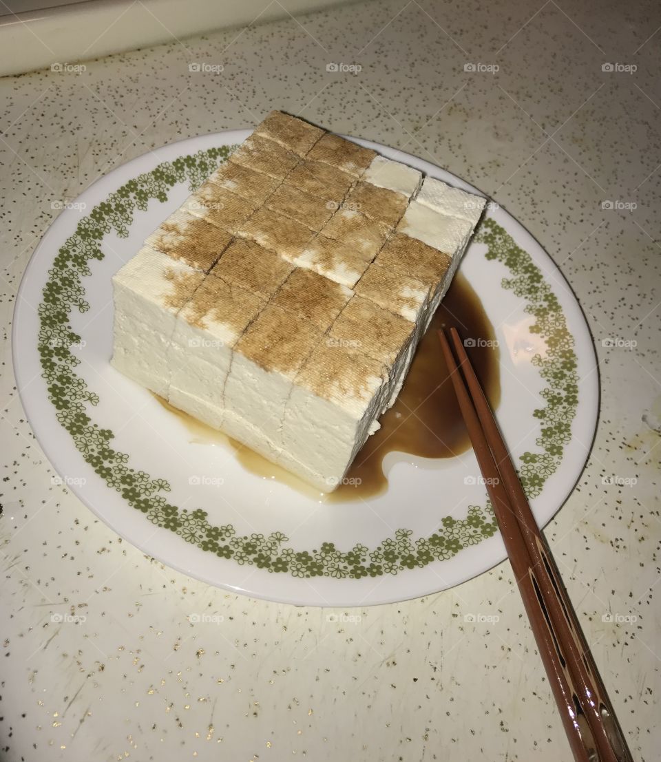 Tofu for dinner. It is a healthy way to eat dinner. Soy sauce and olive oil are added to make the food healthier for consumption.