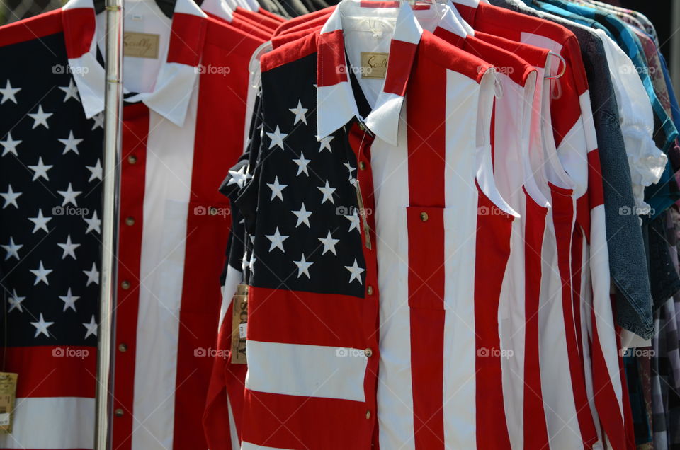 A variety of sizes of patriotic shirts for sale at the rodeo!