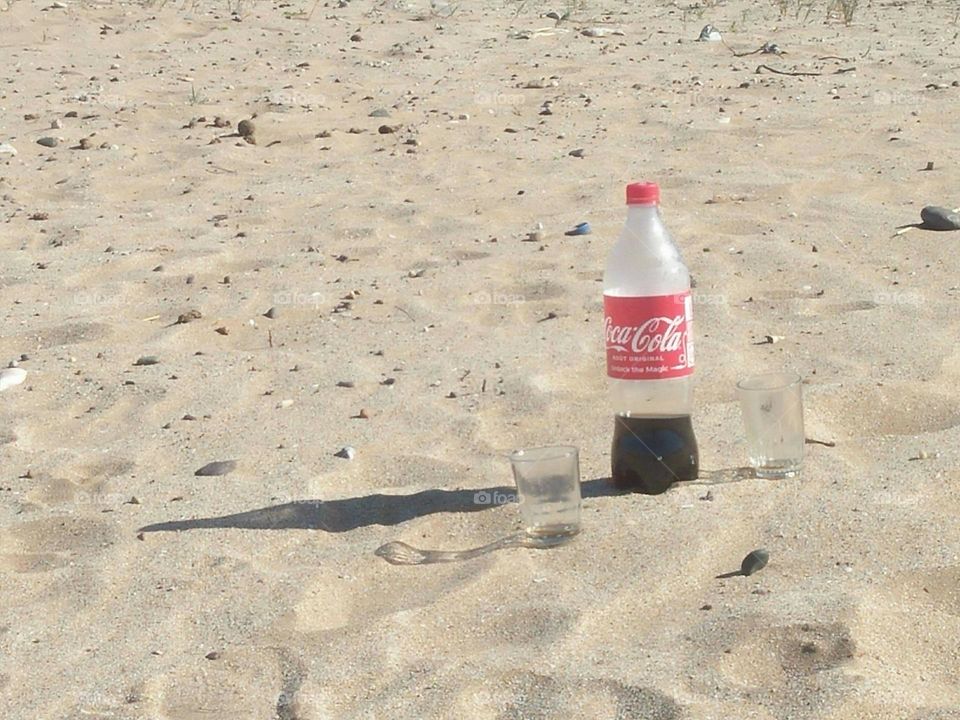 A fresh Cocacola on sand a essaouira city in Morocco.