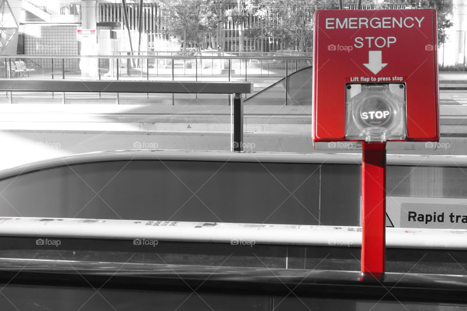 Emergency Stop Botton in train station.Red spotted monochrome image.