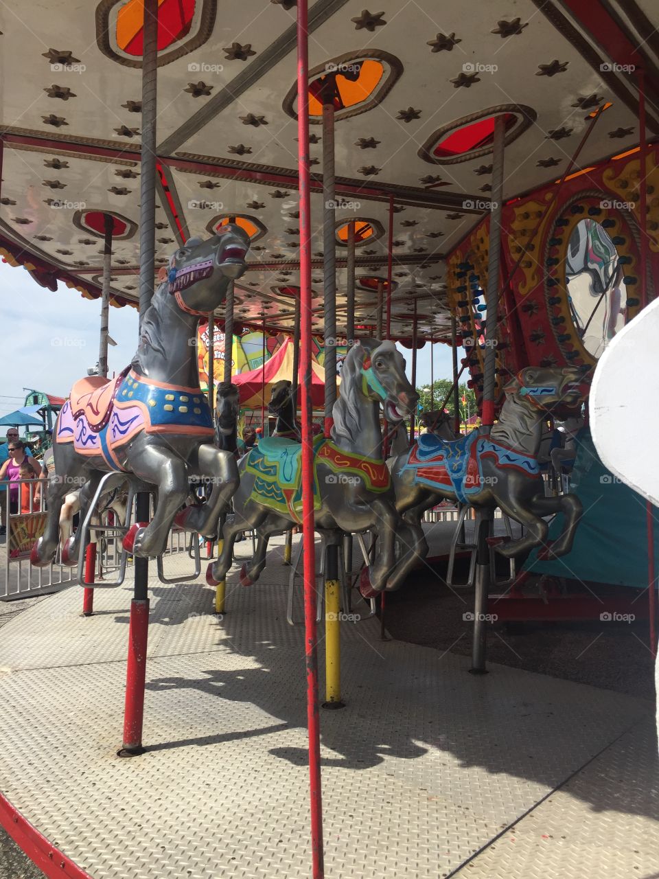 Line of colorful carousel horses at fair