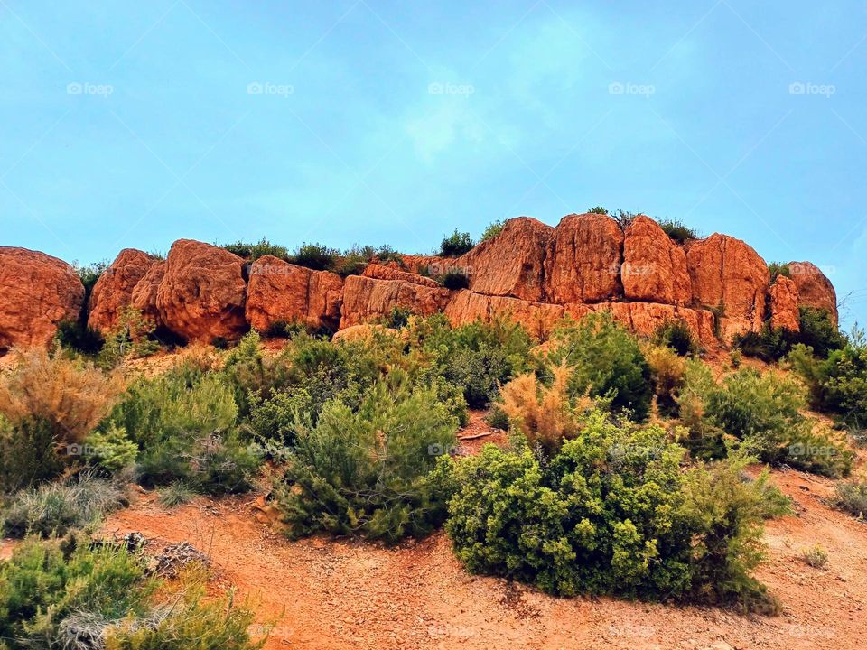 Where the Earth wears its fiery crown, and whispers of ancient stories echo through the stones.