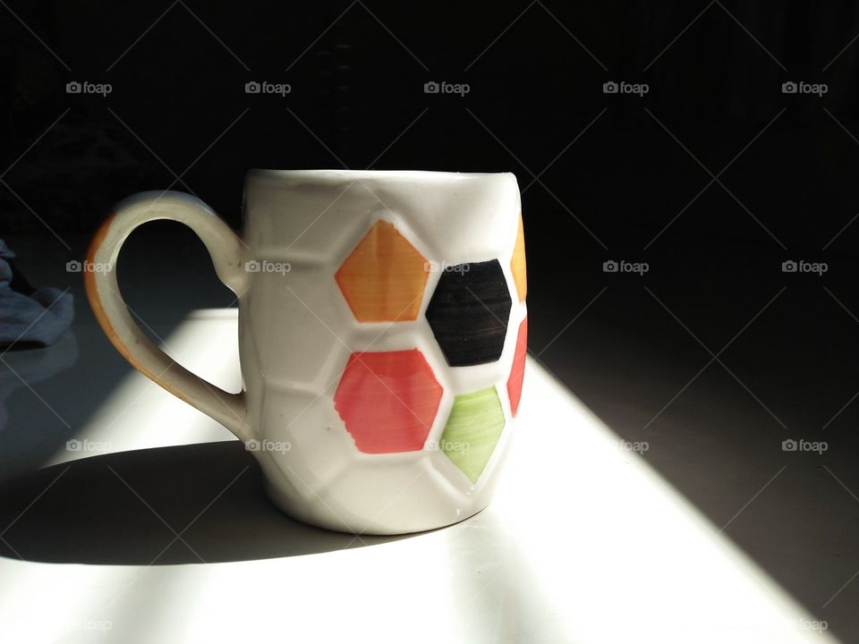 This is image of a coffee mug. It is kept in sunlight, with beautiful design.