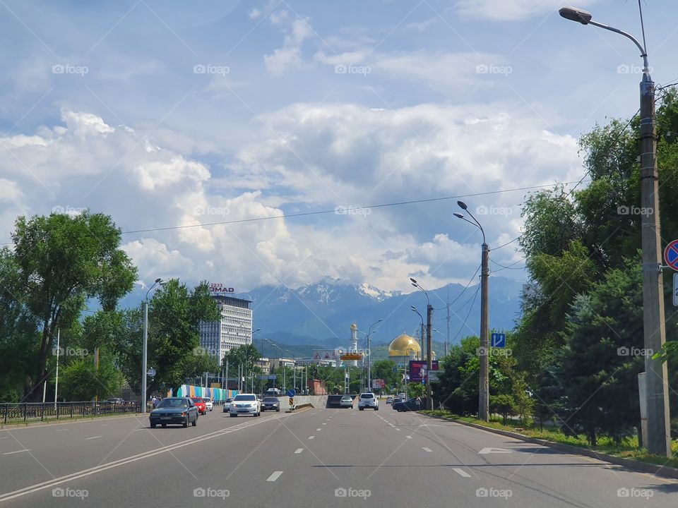 Almaty mountains and central mosque and traffic