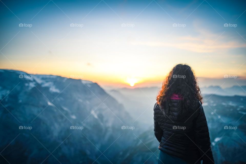 Woman looking in to the wide alps