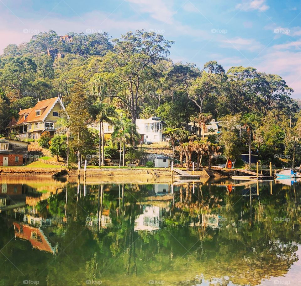 Reflections of houses at Mccarrs Creek Sydney 
