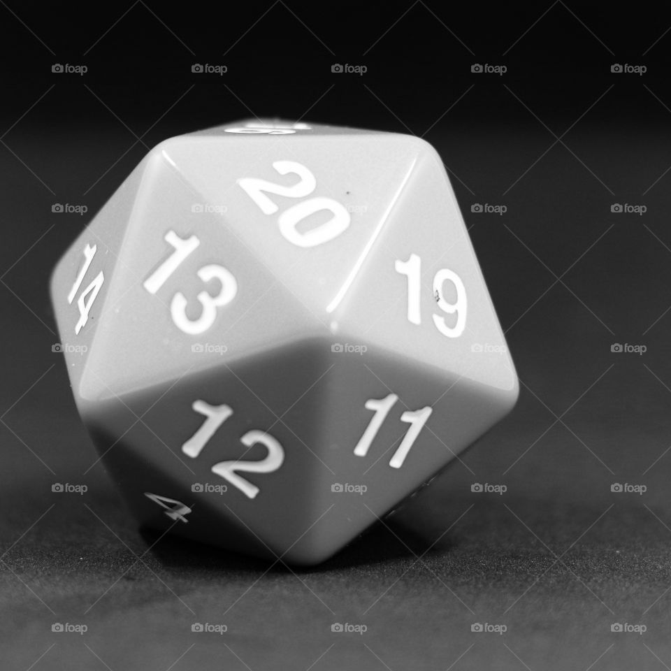A green D20 countdown die in black and white
