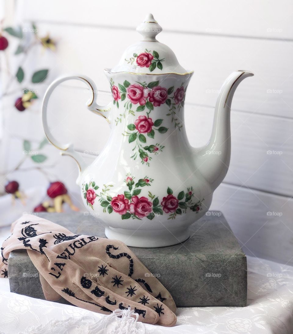 Antique porcelain teapot with roses 