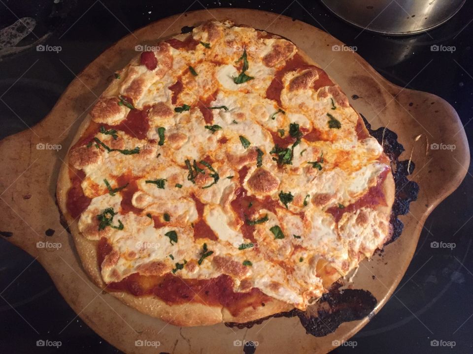 Homemade pizza on a pizza stone