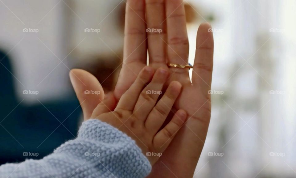 Baby hand and woman hand