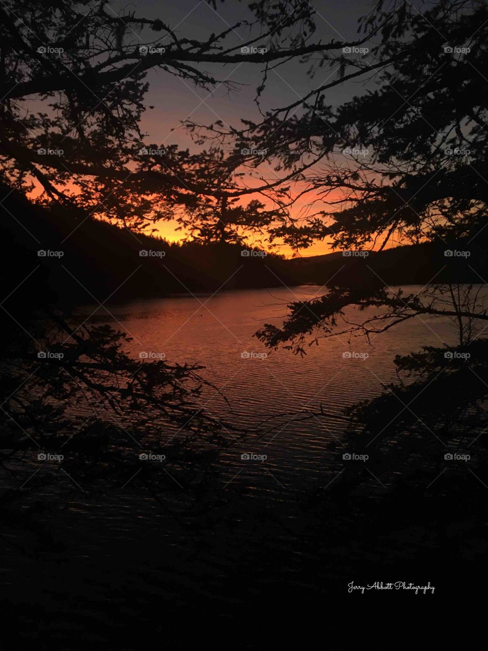 Sun setting over Cascade Lake on Orcas Island, which is part f the San Juan Islands of Washington State 