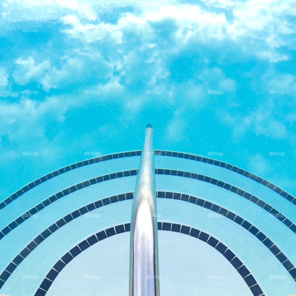 evening sky and clouds reflected in pool 