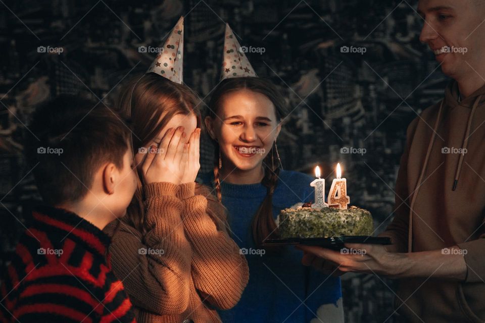 Family celebrating teen girl birthday 