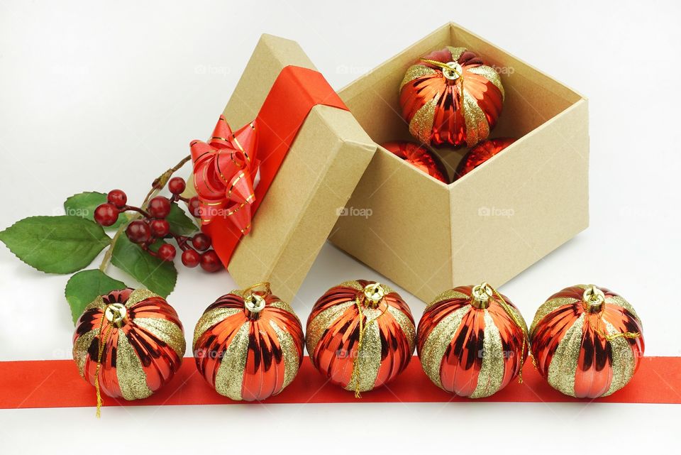 Christmas gift box and ornaments on white background