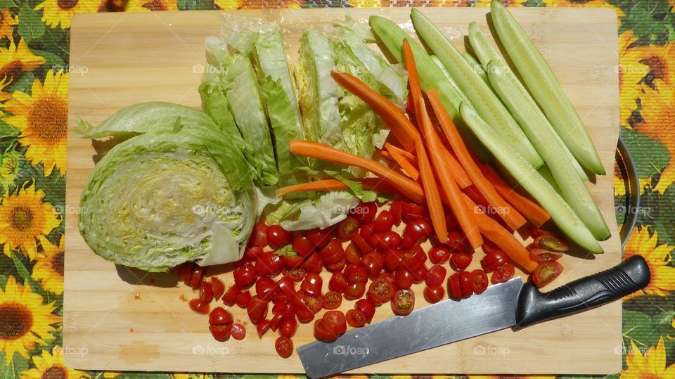 Chopping board with vegetables. After a work of cut a lot of vegetables are on chopping board