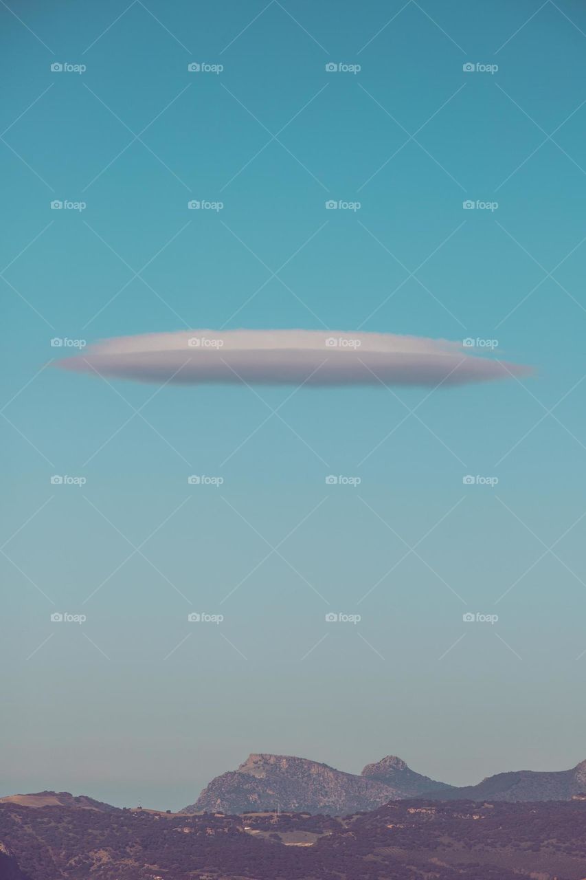 UFO cloud in the blue sky