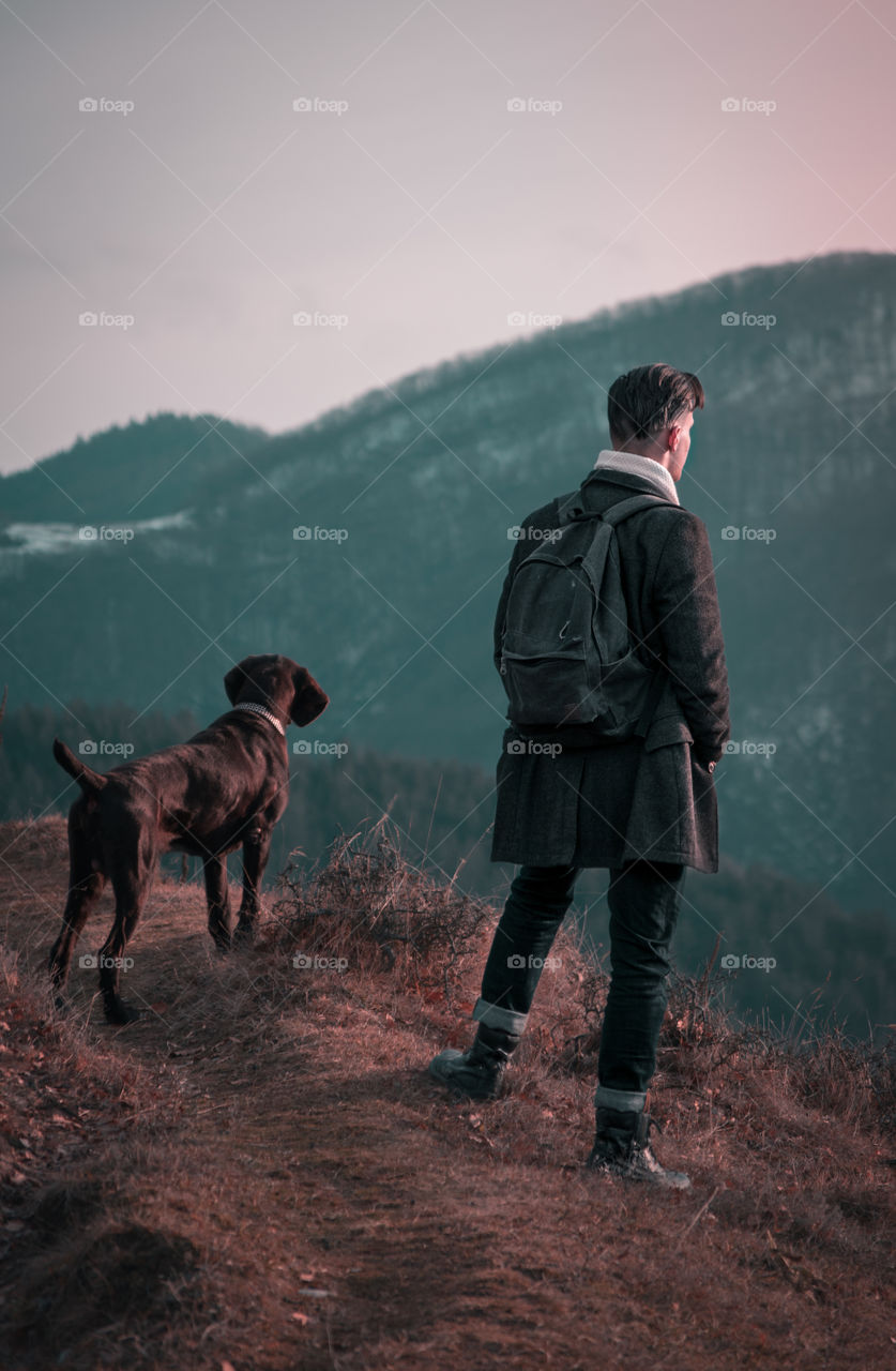 Man and a dog in the mountains.