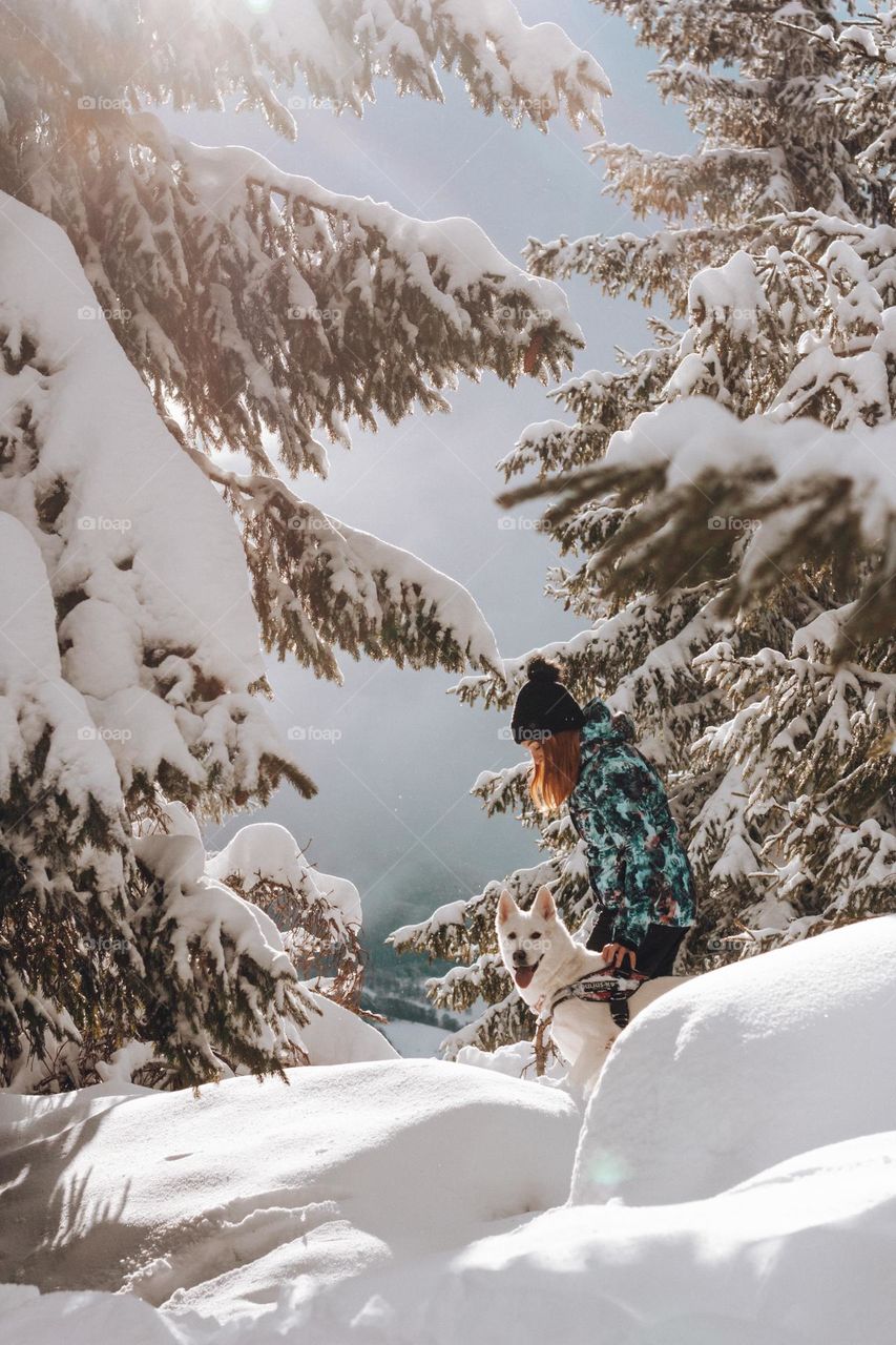 woman enjoying a walk in the woods with her wolfdog
