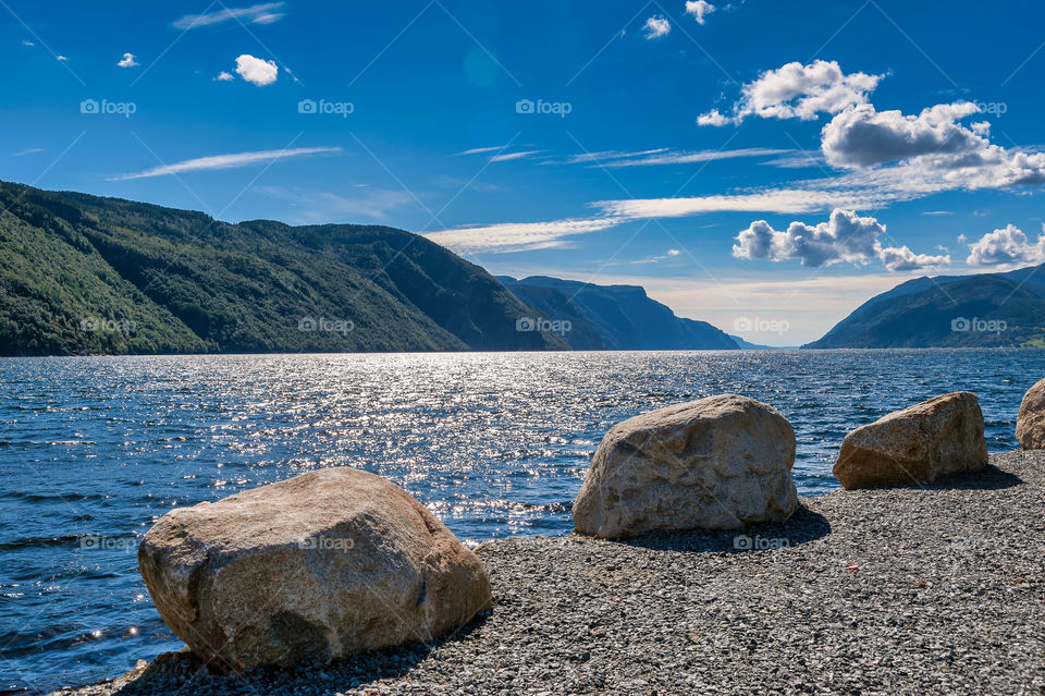 Three boulders on fjords bankside. Norway. Europe.