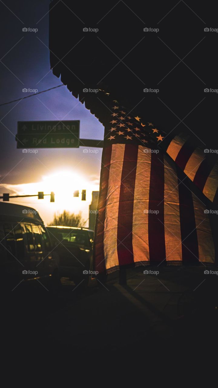 Dark American flag and the city’s light