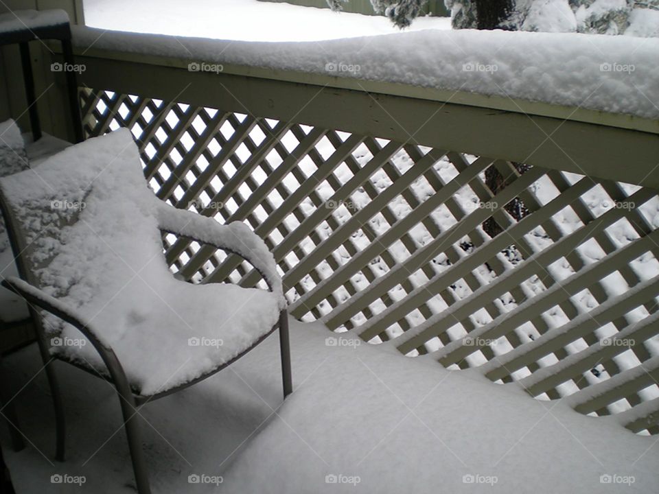 white snow covered deck chair and railing in Oregon Winter scene