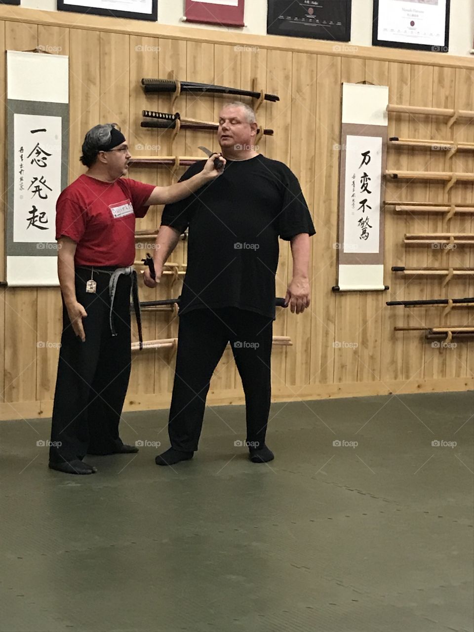 Martial arts training at the dojo. The sensei (left) is teaching the student (right) a counteractive combat technique that would save his live in the future.