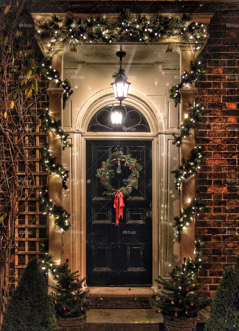 Christmas Doorway. A traditional doorway decorated with a wreath and lights in time for Christmas.