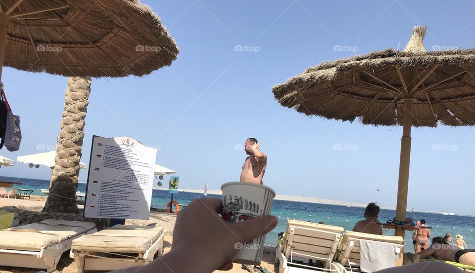 A man coming out of a cup of coffee.